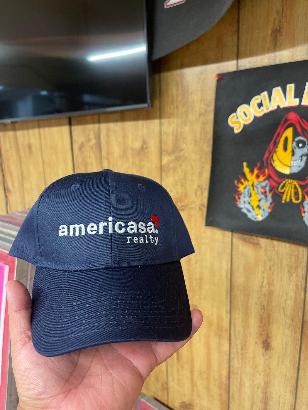 Navy Americasa Realty cap with white and red embroidered logo.