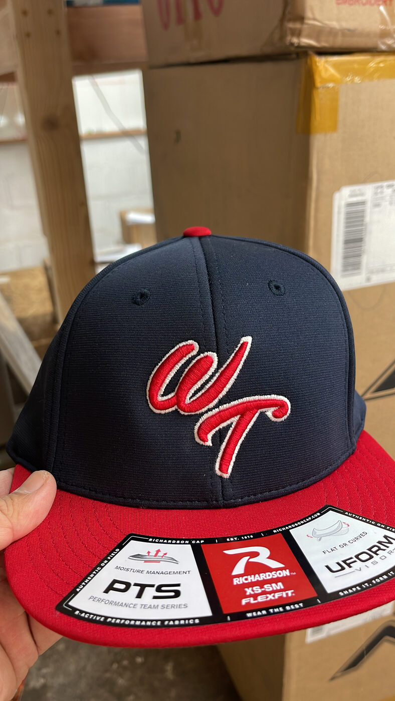 Navy and red two-tone cap with red WT script embroidery.